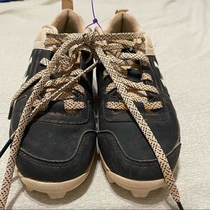 Black and white under armor cleats.